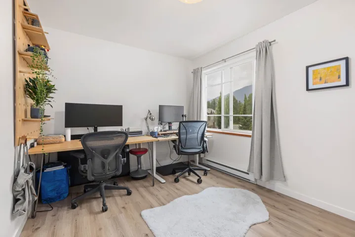 Office area featuring a baseboard radiator and wood finished floors