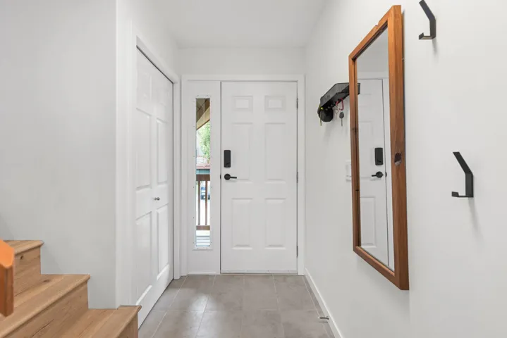 Foyer with stairs and light tile patterned floors