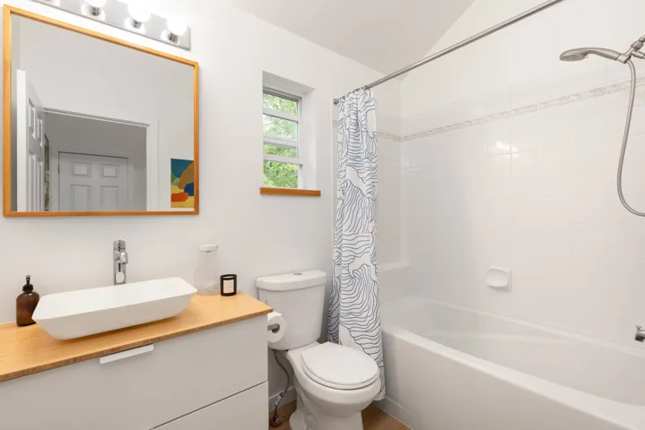 Full bathroom with vanity and shower / bath combo with shower curtain