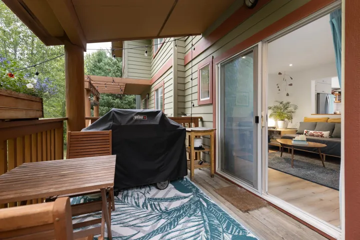 Wooden deck featuring a grill and outdoor dining area