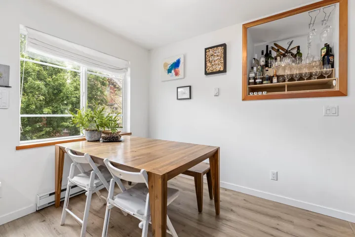 Dining area featuring wood finished floors and baseboard heating