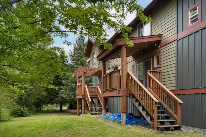 View of play area with stairway, a lawn, and a pergola