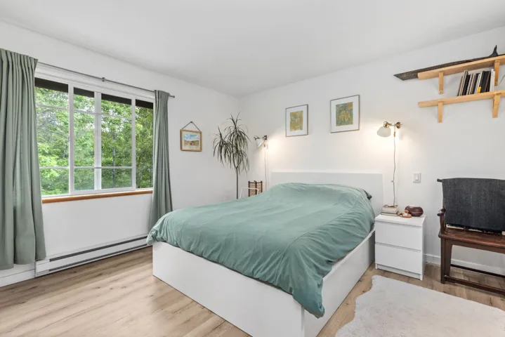 Bedroom featuring a baseboard radiator and wood finished floors