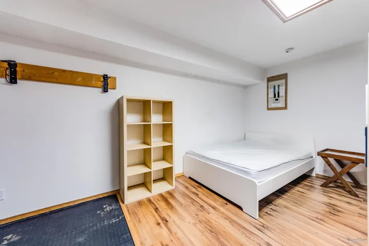 Bedroom with baseboards and wood finished floors