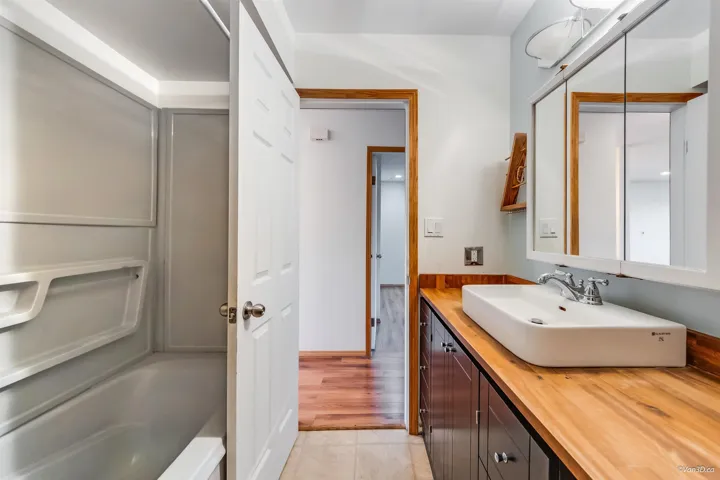 Bathroom with tile patterned floors and vanity