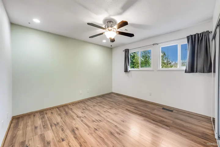 Unfurnished room with baseboards, light wood-style flooring, visible vents, and a ceiling fan