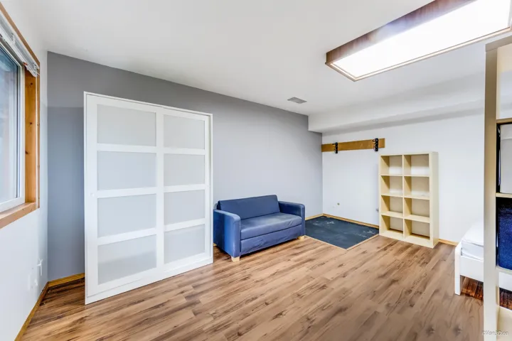 Living area featuring wood finished floors, baseboards, and visible vents