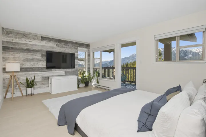 Primary bedroom with private balcony overlooking the fabulous views.   Upper Primary bedroom on it's own floor.