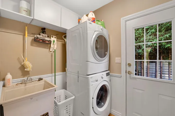 Laundry room featuring stacked washer / dryer