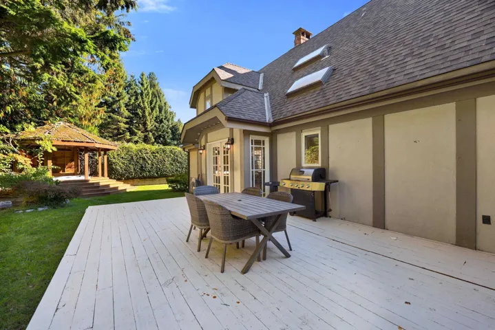 Deck featuring a gazebo, outdoor dining area, a yard, and grilling area