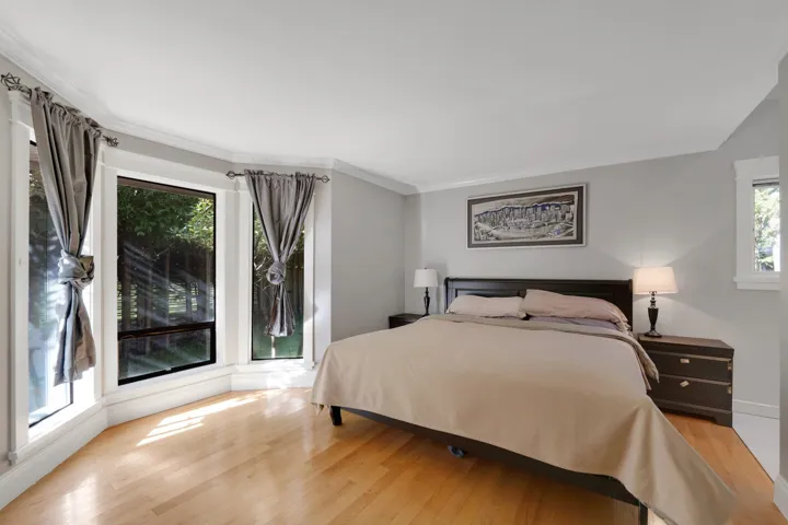 Bedroom with light wood-style floors and crown molding