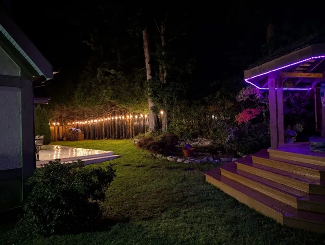 Yard at night featuring a wooden deck