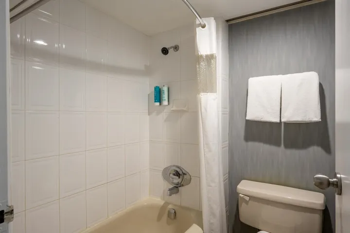 Bathroom featuring toilet and shower / bath combo