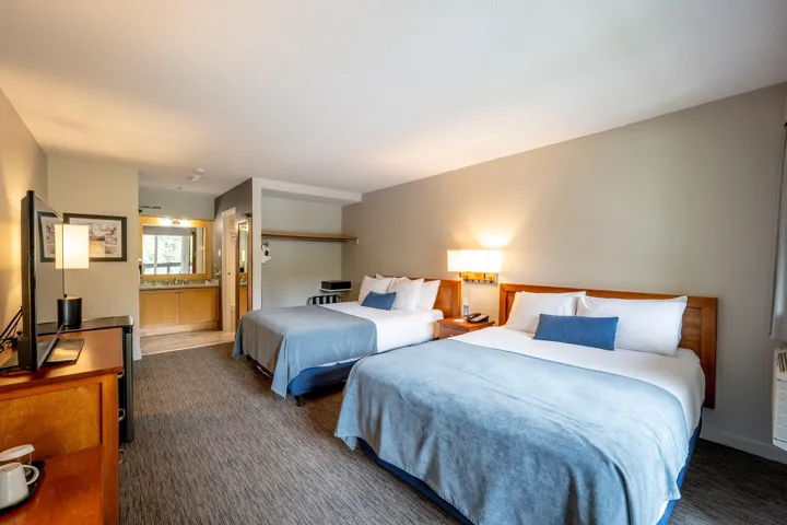 Bedroom with dark colored carpet and ensuite bathroom