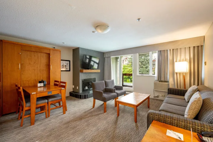 Living room with carpet floors and a tile fireplace