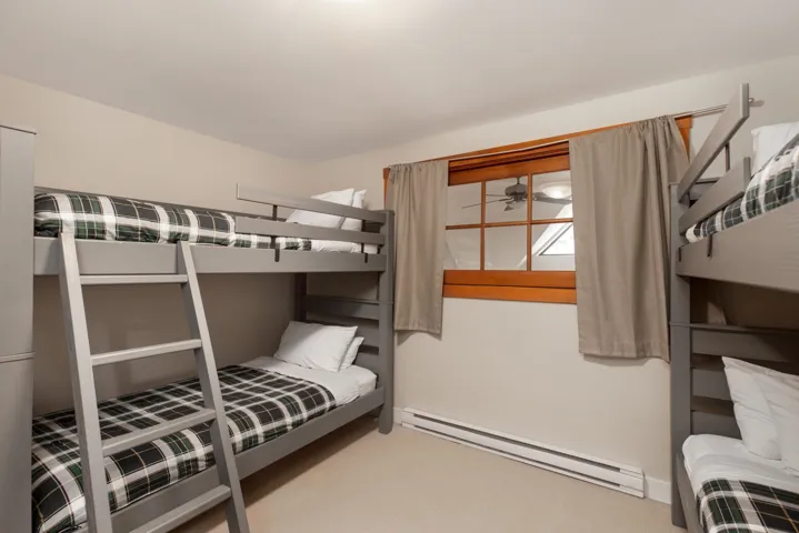 Bedroom featuring a baseboard heating unit and light colored carpet