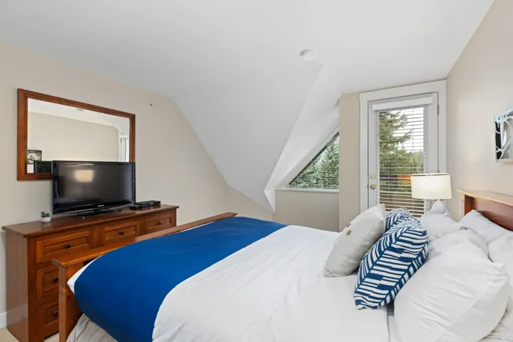 Bedroom featuring lofted ceiling