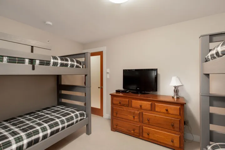 Bedroom with light carpet and baseboards