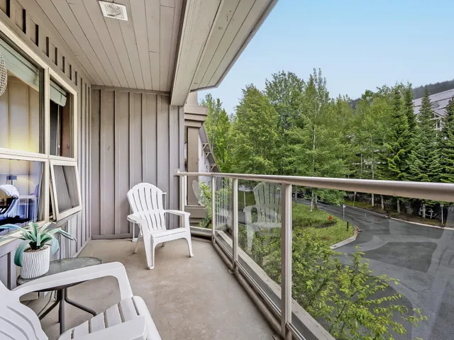 Balcony featuring view of scattered trees