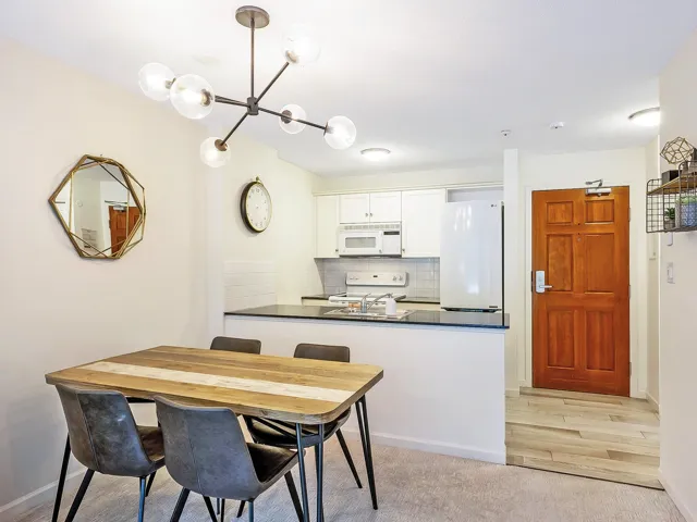 Dining room with a chandelier and light colored carpet