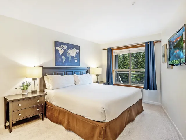 Bedroom with baseboards and light colored carpet