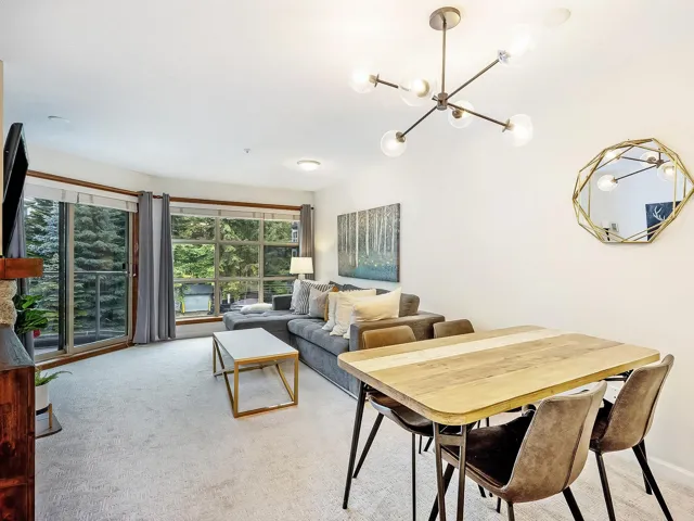 Living room with light carpet and a chandelier