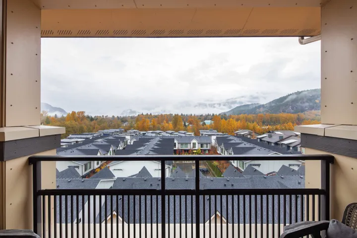 Balcony featuring a residential view and a mountain view
