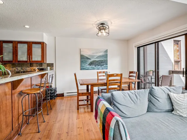 Dining area featuring a textured ceiling, recessed lighting, light wood-style floors, and a baseboard radiator