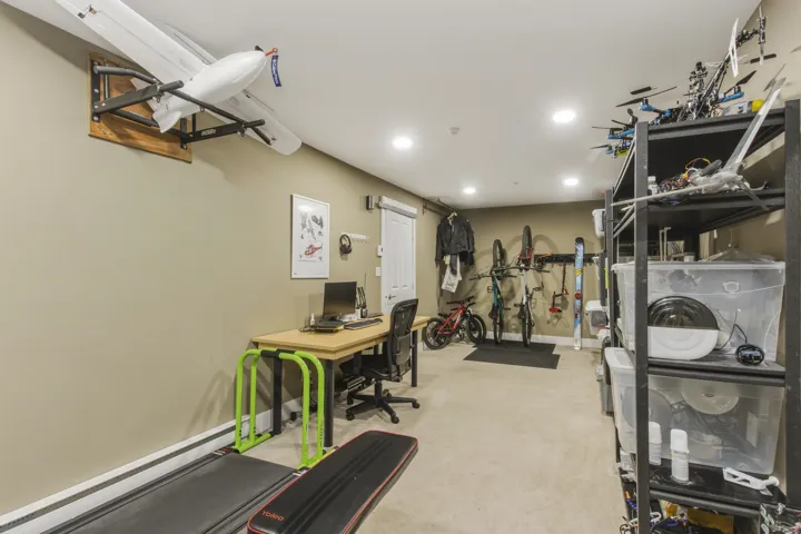 Carpeted room with recessed lighting and neutral wall paint