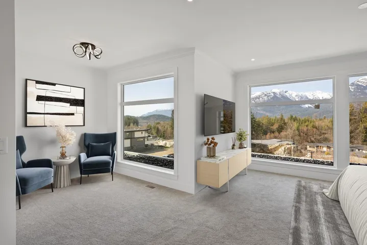Living area with ornamental molding, carpet flooring, and healthy amount of natural light