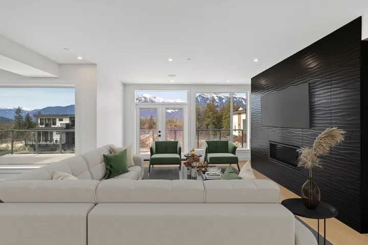 Living room with a large fireplace and recessed lighting