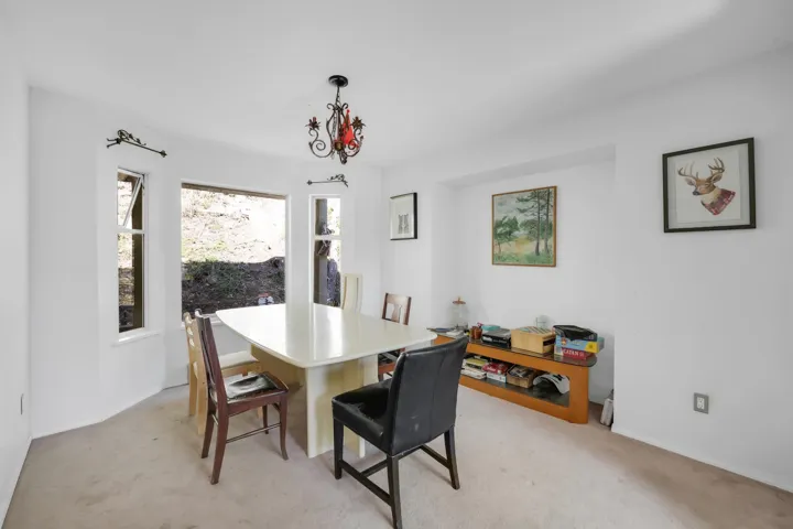Dining space featuring baseboards and light colored carpet