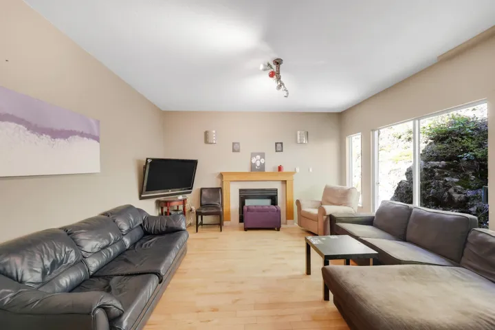 Living area with a fireplace and light wood-style floors