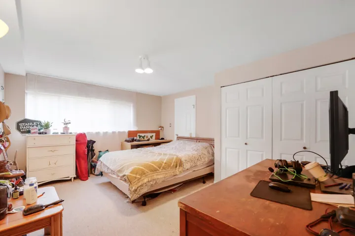 Bedroom featuring carpet and a closet