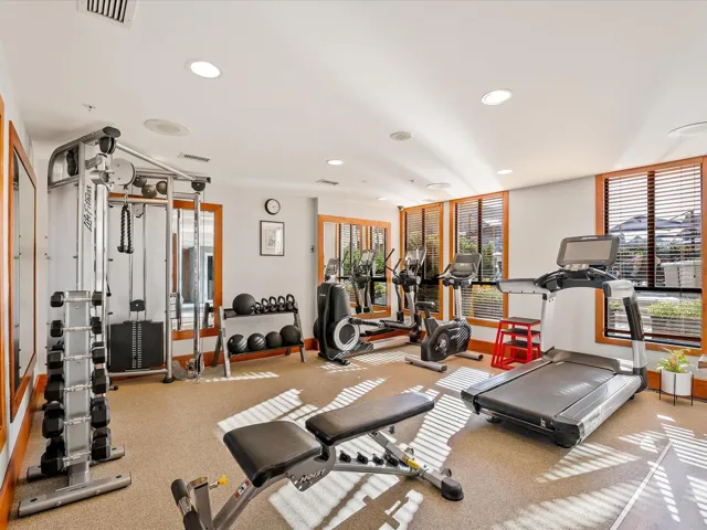 Exercise room with recessed lighting, visible vents, and baseboards