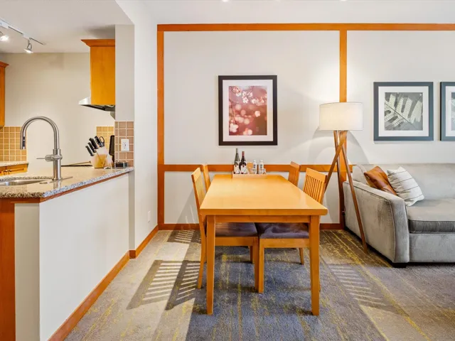 Dining space featuring carpet flooring, track lighting, and baseboards