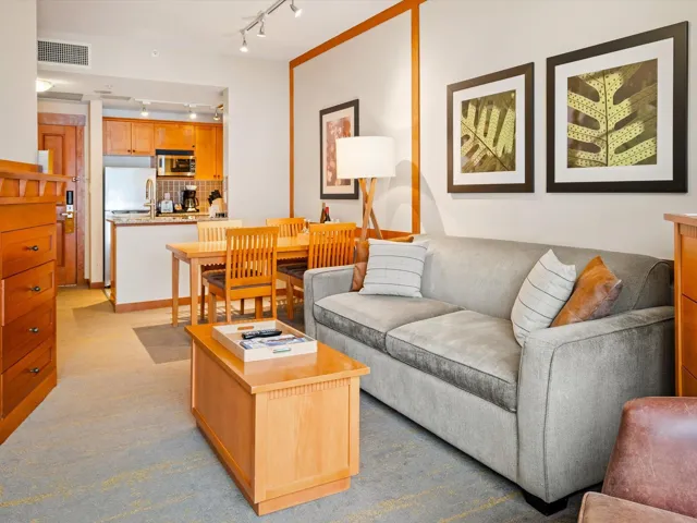 Living room with visible vents, light colored carpet, and rail lighting