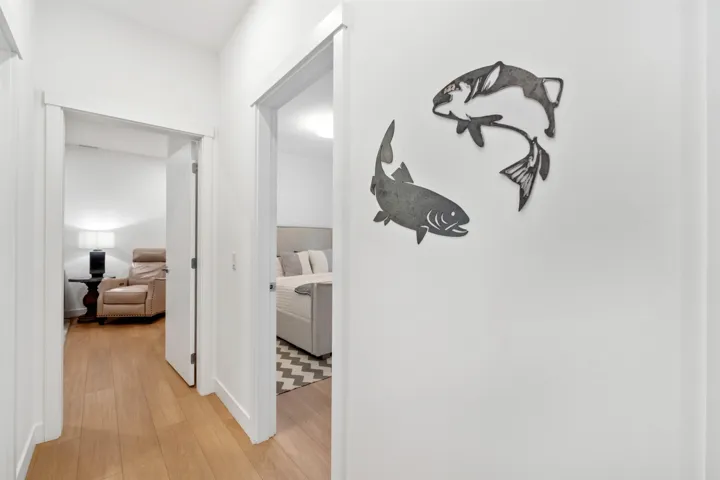Hallway with light wood-finish flooring and white walls