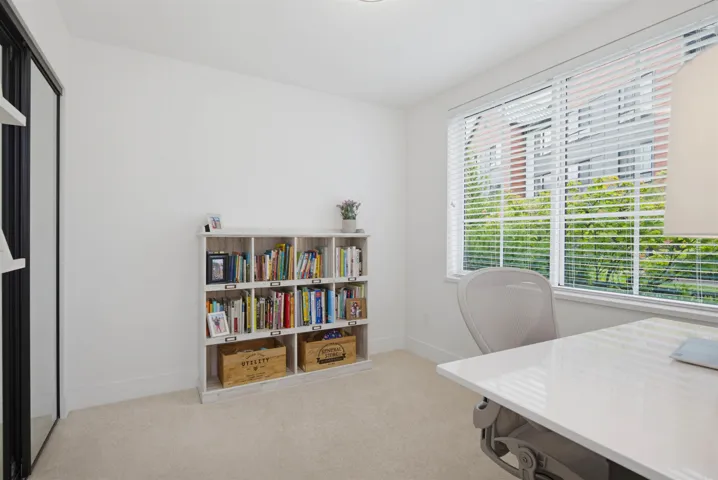 Bright entryway featuring a frosted glass panel door, white walls, and light-toned tile flooring