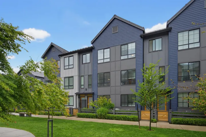 Modern multi-story facade featuring board and batten siding and distinct architectural lines