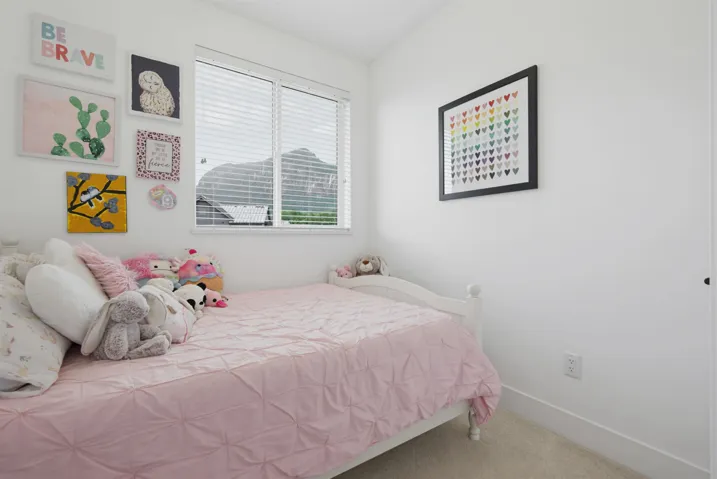 White interior walls with a frosted glass panel door, light-toned tile flooring, and a louvered window
