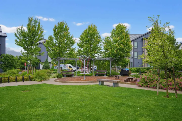 Expansive green lawn with a surrounding paved pathway