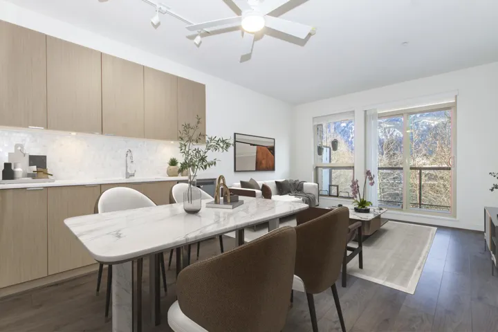 Dining area featuring lofted ceiling, a ceiling fan, and dark wood-type flooring