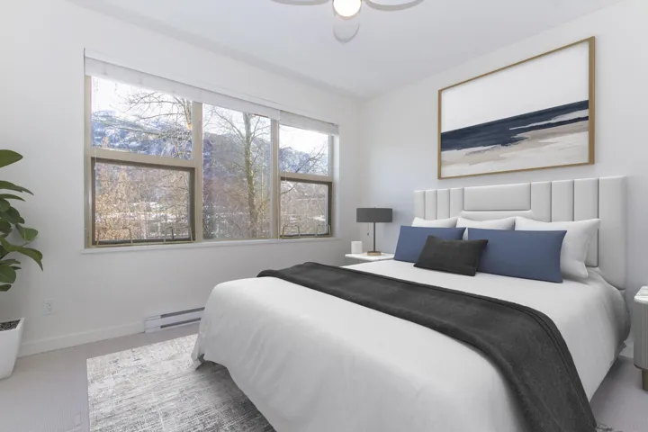 Carpeted bedroom featuring a baseboard heating unit and baseboards