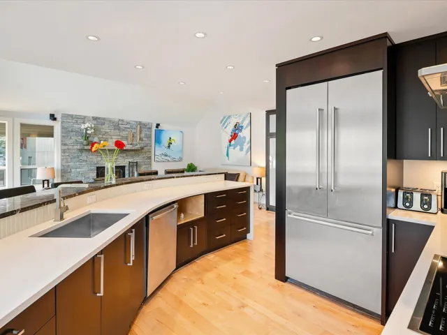 Kitchen featuring appliances with stainless steel finishes, light countertops, and a sink