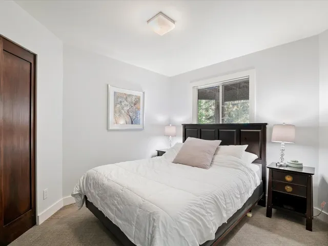 Carpeted bedroom featuring baseboards