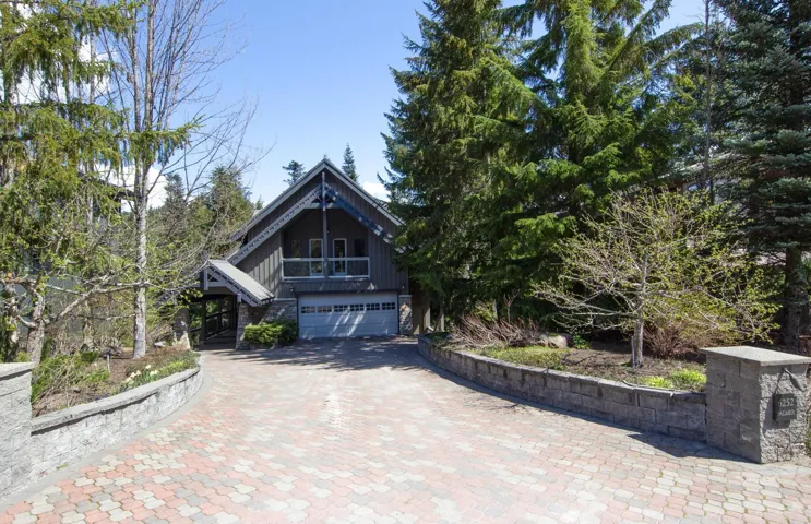 View of front of house featuring decorative driveway and a garage