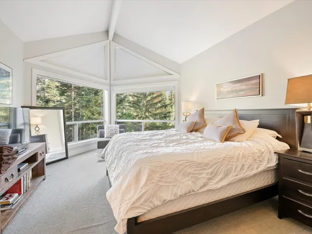 Bedroom featuring lofted ceiling and carpet floors