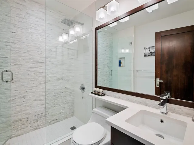 Bathroom with a stall shower, toilet, and vanity