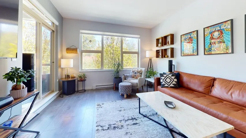 Living area with  wood finished floors and direct deck access